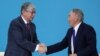 Kazakhstan's President Tokayev shakes hands with former President Nazarbayev at a congress of the Nur Otan ruling party in Nur-Sultan