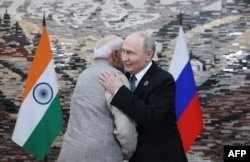 Russian President Vladimir Putin and Indian Prime Minister Narendra Modi greet each other on the sidelines of the Shanghai Cooperation Organization summit in Bishkek on August 31.