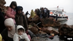 Migrants arrive on the Greek island of Lesbos on an overcrowded fishing boat after crossing the Aegean sea from Turkey.