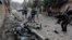 Afghan journalists film at the site of a bombing attack in Kabul on February 20.