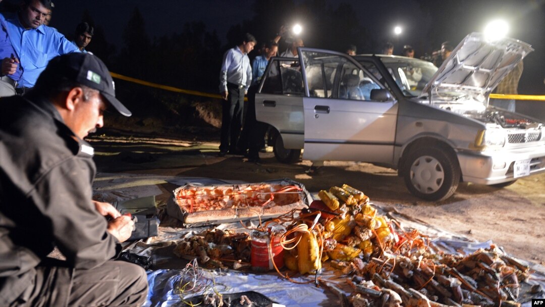 Pakistani security officials search a vehicle found packed with explosives after its seizure by police on the outskirts of Islamabad on April 23.