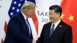 June 28, 2019 shows China's President Xi Jinping (R) shaking hands with US President Donald Trump before a bilateral meeting on the sidelines of the G20 Summit in Osaka