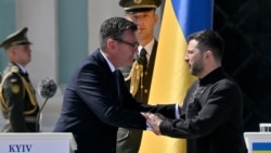 Britain's Prime Minister Andy Burnham shakes hands with Ukraine's President Volodymyr Zelenskyy during a commemorative ceremony marking Ukraine's 35th Independence Day outside St. Sofia cathedral in Kyiv on August 24, 2026.