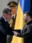 Britain's Prime Minister Andy Burnham (L) shakes hands with Ukraine's President Volodymyr Zelensky (R) during a commemorative ceremony marking Ukraine's 35th Independence Day outside St. Sofia cathedral in Kyiv on August 24, 2026.