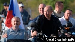 Russian President Vladimir Putin drives a motorcycle during a bike show outside Sevastopol, Crimea, on August 10.