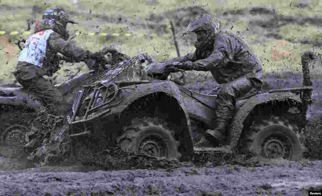 Riders compete during the "Kings Of The Off-Road" quad bike amateur regional race in the Siberian village of Kozhany. (Reuters/Ilya Naymushin)