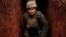 UKRAINE – A Ukrainian service member walks along a trench at a position on the front line near the city of Novoluhanske in the Donetsk region, February 22, 202