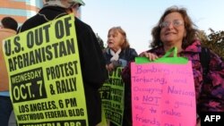 Antiwar protesters mark the eighth anniversary of military action in Afghanistan at a demonstration outside the Federal Building in Los Angeles.