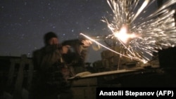 A Ukrainian soldier fires during fighting with pro-Russian separatists in Avdiyivka, near Donetsk.