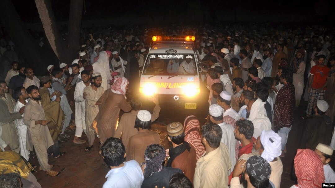 Supporters of Malik Ishaq, chief of the Al-Qaeda-linked Laskhar-e-Jhangvi in the Punjab region, wait for the arrival of his body for burial before his funeral in Rahimyarkhan in southern Punjab Province on July 29.