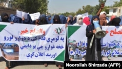 Afghan women march in Jalalabad in support of the peace talks between the Afghan government and the Taliban as they demanded a permanent cease-fire on September 16.