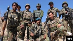 Afghan soldiers pose for a group photo during a patrol in Helmand province on February 14.