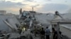 People and first-responders gather atop a building that was hit by an Israeli strike in Tehran on June 13, 2025.