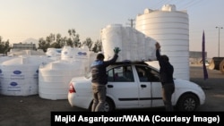 People purchase water storage tanks amid the drought crisis in Tehran on November 10.