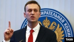 Russian oppositionist Aleksei Navalny talks to reporters before the Central Election Commission's decision was announced on December 25. 