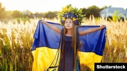 A girl carries fluttering blue and yellow flag of Ukraine. (Illustrative photo)