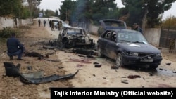 Police investigators work at the site of the attack on the Tajik-Uzbek border.