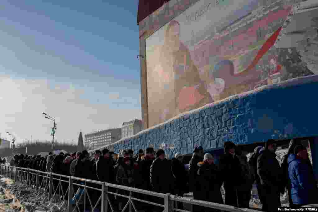 People line up to pay their last respects to rescue workers at a sports hall in Vorkuta. On February 28, another huge blast at Severnaya killed six rescue workers who were trying to find miners who had gone missing in the initial explosion three days earlier. The rescue operation was subsequently halted. A few days later, the missing miners were declared dead and officials decided to flood the mine in order to extinguish the fire and prevent a major collapse.