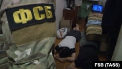Russian Federal Security Service officers detain a suspected Islamic extremist in St. Petersburg on December 15.