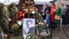 People pay tribute at the grave of late Russian opposition leader Aleksei Navalny on the day of Russia's presidential election in Moscow on March 17.