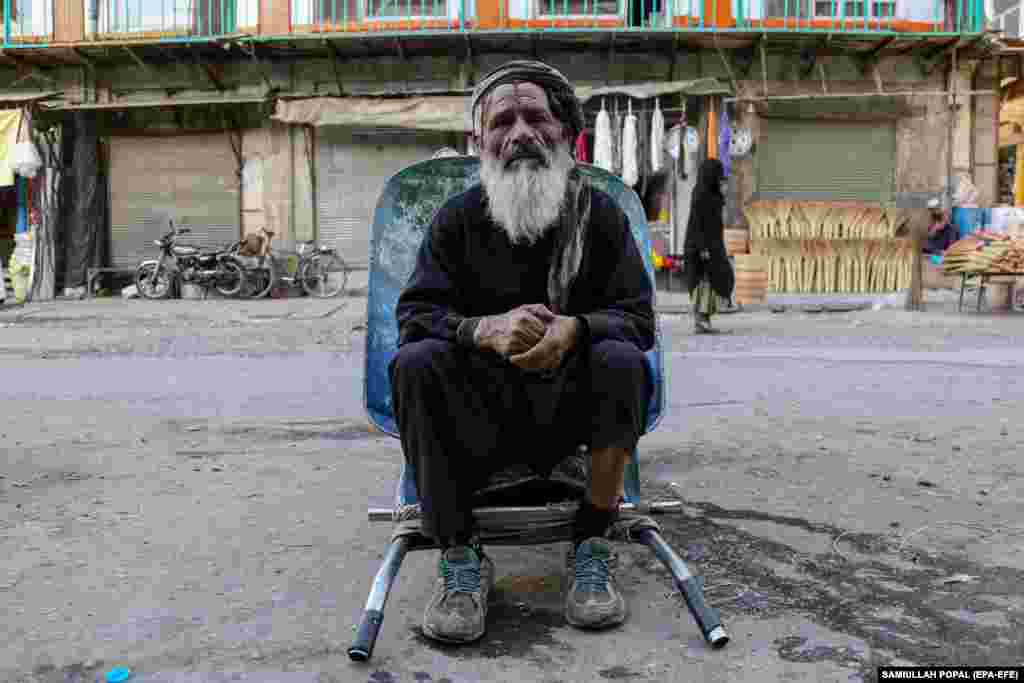 A day laborer waits for work on a roadside in Kabul.