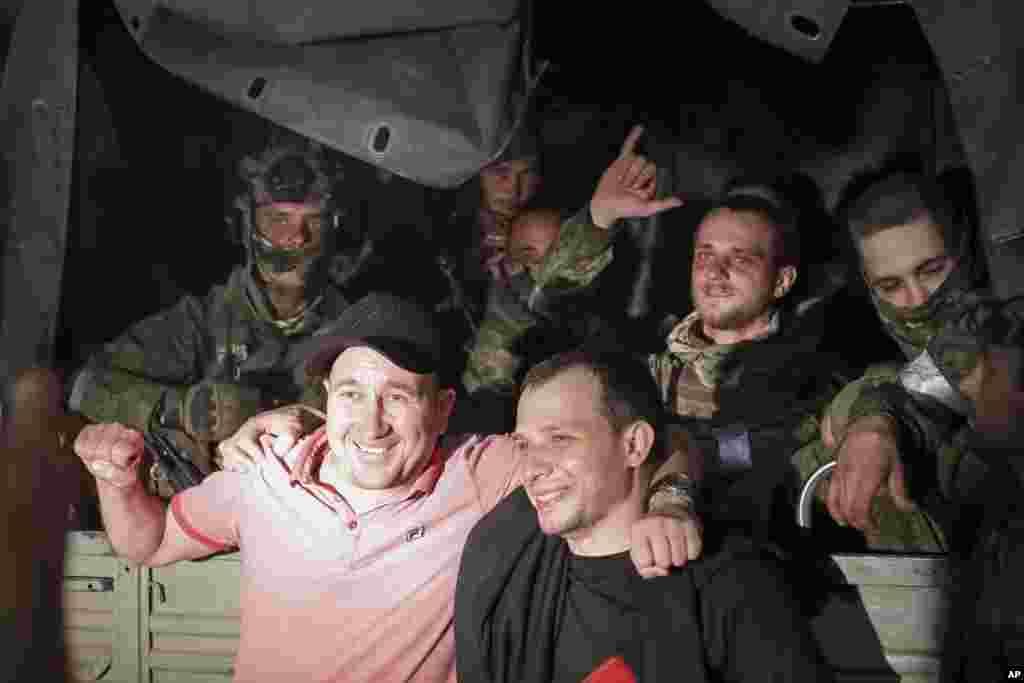 Two men pose for a photo with members of the Wagner mercenary group as they wait in their military vehicle on a street in Rostov-on-Don. The &quot;march for justice&quot; by Prigozhin and his troops was the biggest internal challenge President Vladimir Putin has faced to his rule.