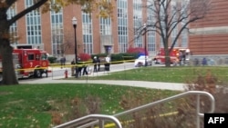 A photo from the student daily newspaper of Ohio State University, The Lantern, shows police securing an area on the campus in Columbia following reports that a shooter was on the loose. 