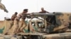 Iraqi soldiers load a projectile into a multiple rocket launcher east of Mosul on October 24. 