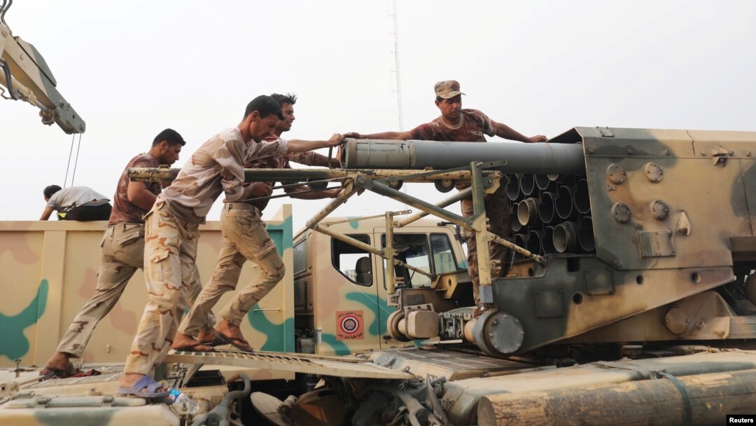 Iraqi soldiers load a projectile into a multiple rocket launcher east of Mosul on October 24. 