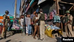 Indian police frisk a Kashmiri man during a search operation ahead of a concert by Zubin Mehta in Srinagar.