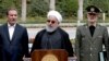 Iranian President Hassan Rohani, center, speaks during a media briefing after a cabinet meeting, as senior Vice President Eshaq Jahangiri, left, and Defense Minister Gen. Amir Hatami listen, in Tehran, March 18, 2019