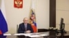 Russian President Vladimir Putin holds a government meeting on Crimea, the Ukrainian peninsula occupied by Russia 12 years ago, by video link from one of his offices on March 18.