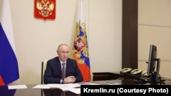 Russian President Vladimir Putin holds a government meeting on Crimea, the Ukrainian peninsula occupied by Russia 12 years ago, by video link from one of his offices on March 18.