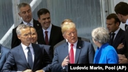 NATO Secretary General Jens Stoltenberg, left, US President Donald Trump and Britain's Prime Minister Theresa May, right, talk during a family picture ahead of the opening ceremony of the NATO summit on July 11.