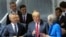 NATO Secretary General Jens Stoltenberg, left, US President Donald Trump and Britain's Prime Minister Theresa May, right, talk during a family picture ahead of the opening ceremony of the NATO summit on July 11.