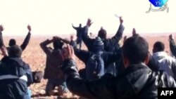 A still image broadcast on Algerian TV shows hostages surrendering to Islamist gunmen at the gas facility.