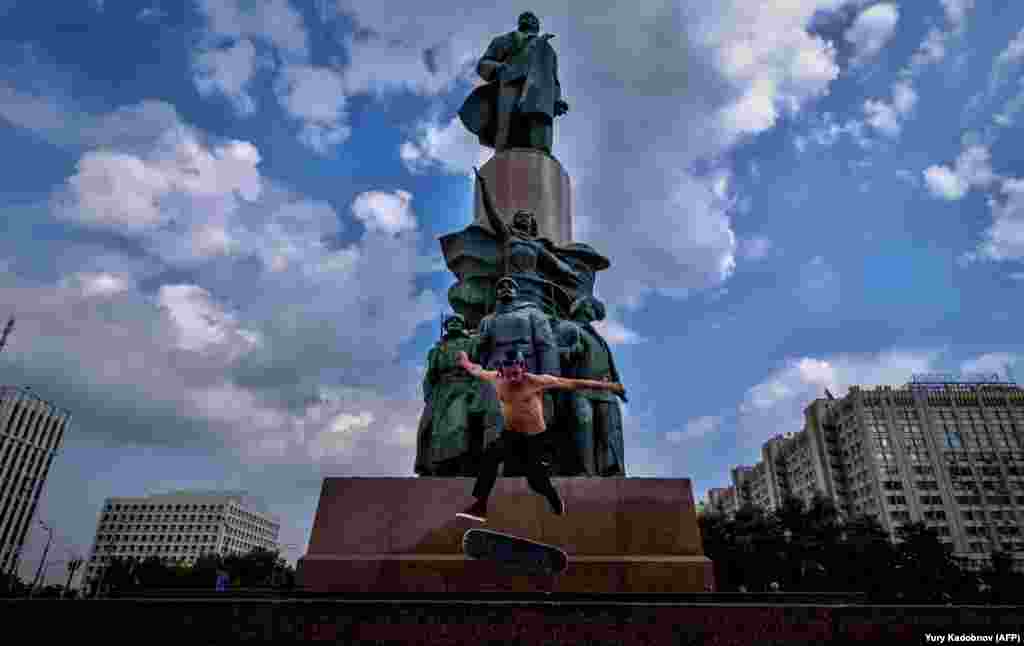 A skateboarder performs a trick in front of a monument to Vladimir Lenin in Moscow. (AFP/Yuri Kadobnov)