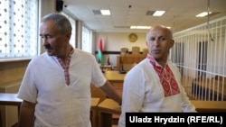 Belarusian union leaders Henadz Fyadynich (left) and union accountant Ihar Komlik in court in Minsk on August 24. 