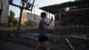 A man walks past a damaged supermarket following a Russian missile strike in the Ukrainian capital of Kyiv on August 1.