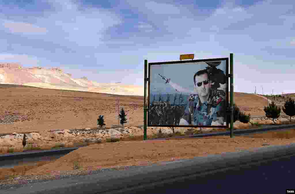 A billboard depicting Syrian President Bashar al-Assad is seen on a road from Damascus to Homs. (TASS/Valery Sharifulin)