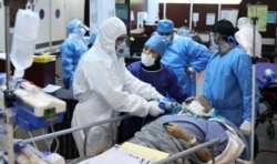 Doktorët në Teheran duke trajtuar një pacient me koronavirus.