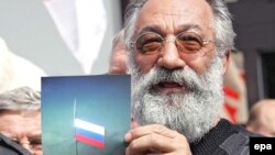 Artur Chilingarov, head of Russian expedition Arctic-2007, shows picture of Russian flag in the seabed below the North Pole in August 2007.