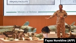 Saudi defense ministry spokesman Colonel Turki bin Saleh al-Malki displays pieces of what he said were Iranian cruise missiles and drones recovered from the attack site that targeted Saudi Aramco's facilities. FILE PHOTO