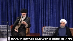 A handout picture released by the official website of the Iranian supreme leader Ayatollah Ali Khamenei shows him (L) speaking during the swearing-in ceremony of Iranian President Hasan Rouhani (R) in Tehran on August 3, 2017