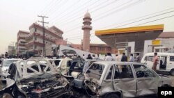 Destroyed vehicles near the site of a bomb blast at a mosque in Lahore