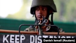 An Indian soldier keeps guard in Srinagar on August 15.