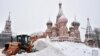 A bulldozer shovels snow off Red Square as snow falls in Moscow on February 4.