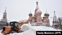 A bulldozer shovels snow off Red Square as snow falls in Moscow on February 4.