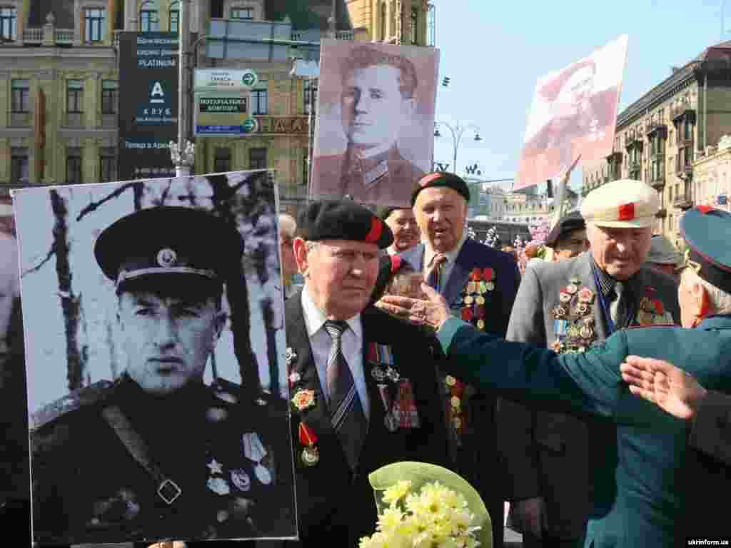 Residents of Kyiv, Ukraine, display photos World War II veterans.