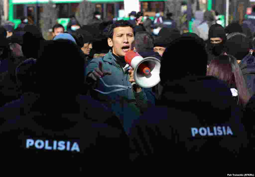 An activist is confronted by police officers during a protest in Almaty, Kazakhstan, on February 28.